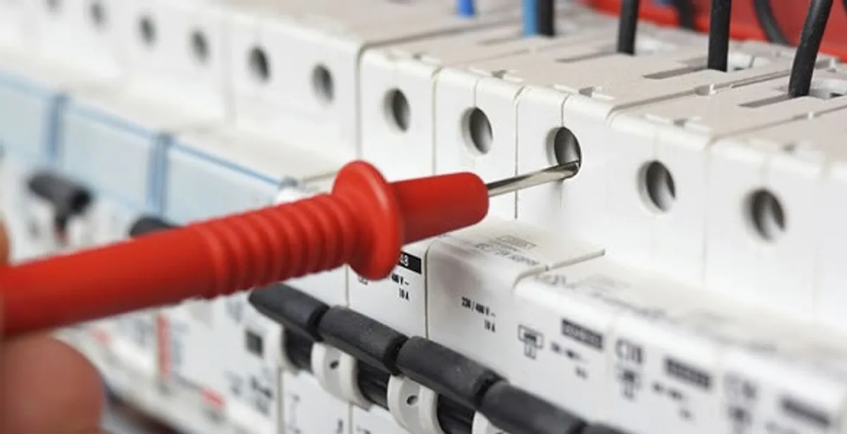 Electrical contractor testing circuit breakers during electrical repair in Laveen, AZ