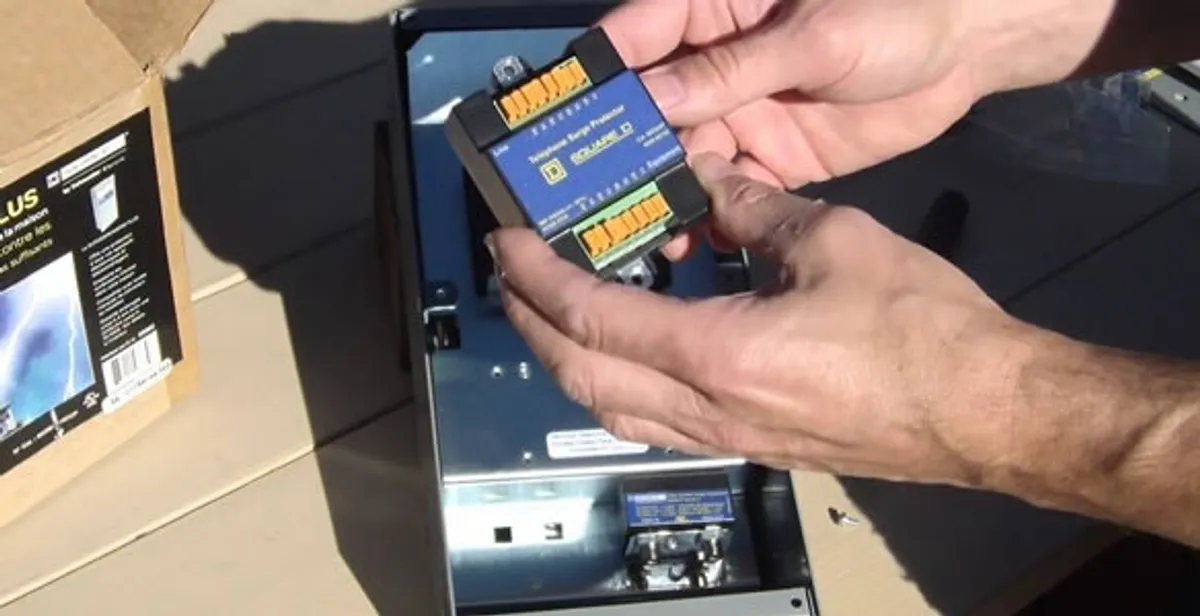 Electrician installing whole home surge protection unit inside main electrical panel in Phoenix, AZ