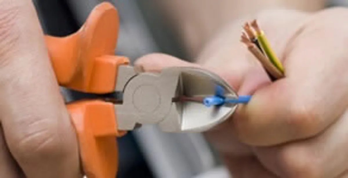 professional electrical services showing precise wire cutting by licensed electricians in Phoenix, AZ